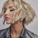 Blonde, wavy short wig styled for a modern look.